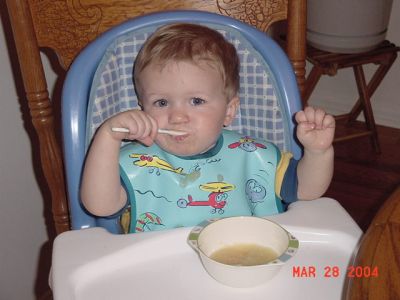 Braydon eating apple sauce.JPG